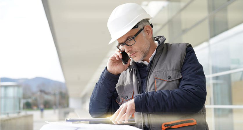 Designer reviewing plans for sprayed plaster in Malaga